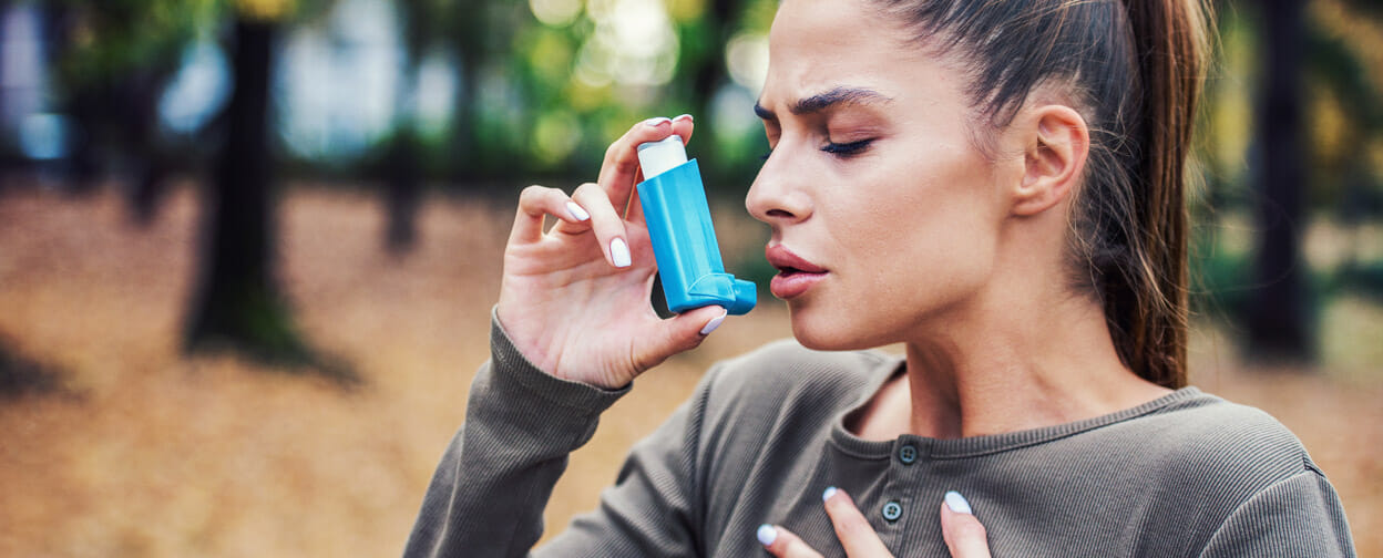 Photo of woman using Asthma Inhaler