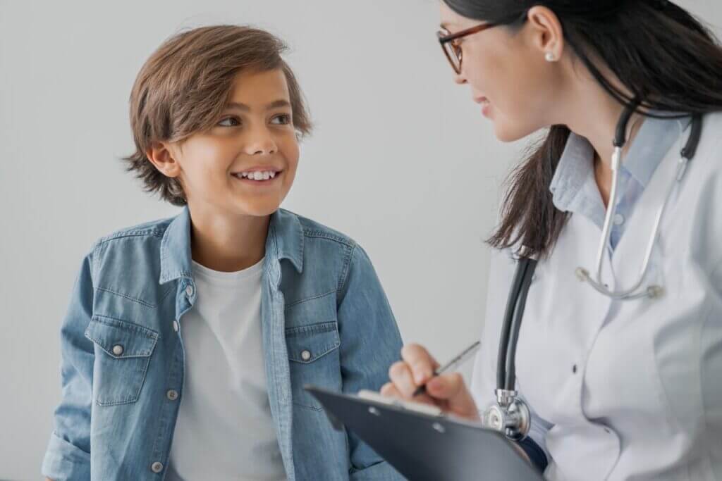 Child reviewing allergy action plan with healthcare provider